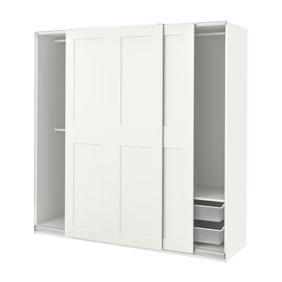 A white PAX wardrobe with sliding doors and shelves inside. Its sleek and modern, with a basic setup for easy organization.