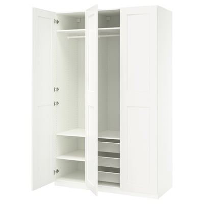 A white PAX wardrobe with open doors, revealing shelves and mesh baskets.