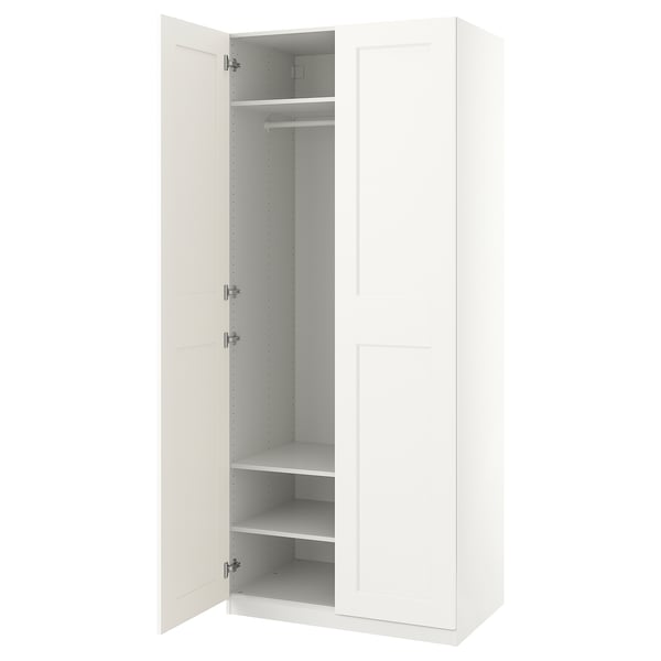 A PAX wardrobe in white with one door open, revealing an empty closet space with shelves inside.