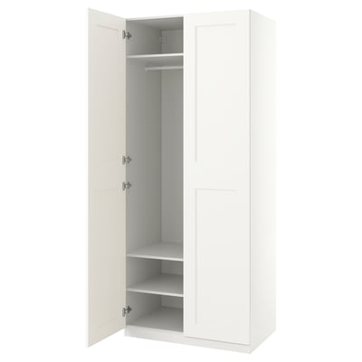 A PAX wardrobe in white with one door open, revealing an empty closet space with shelves inside.