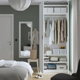 Modern bedroom wardrobe, neatly organizing clothes, bags, and folded garments.