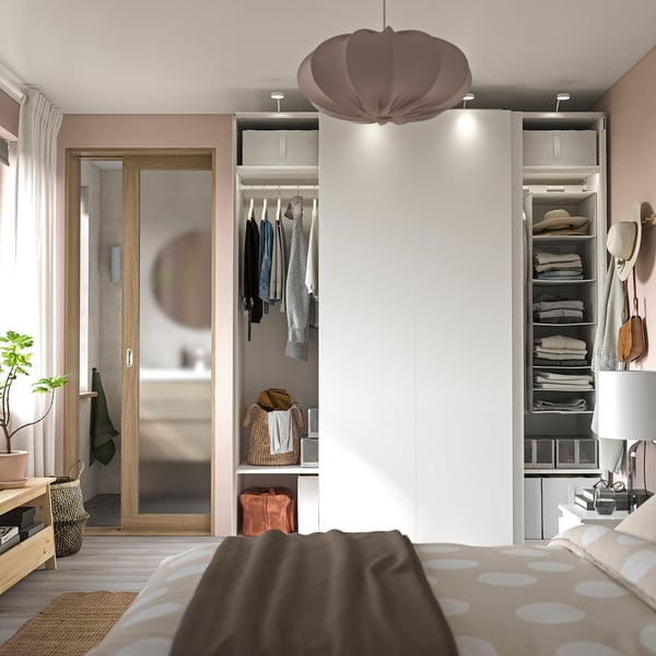 Modern bedroom with white PAX wardrobe, mirrored doors, and polka dot bedding.
