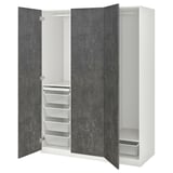 An open white PAX wardrobe with drawers, shelves, and hanging space.