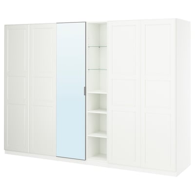 A white IKEA PAX wardrobe with mirrored doors and open shelves. Modern design, perfect for organizing clothes and accessories.