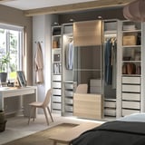 Modern bedroom with beige PAX wardrobe, desk, and chair.