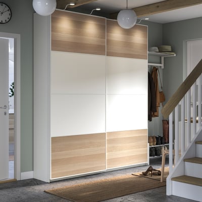 Modern hallway with PAX wardrobe and lighting, white staircase.
