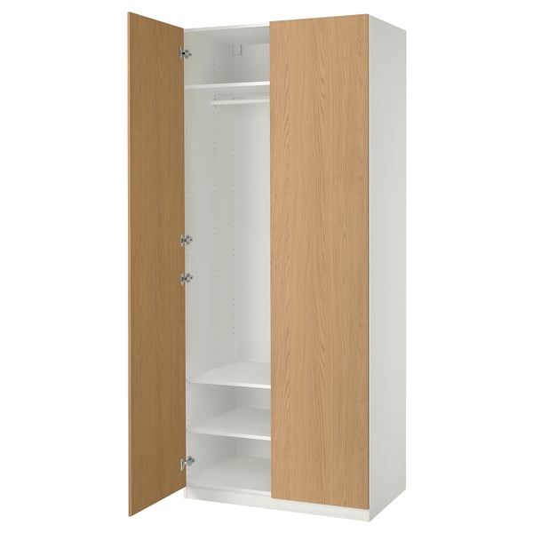 An ikea PAX wardrobe with a light brown door, featuring a white interior with shelves and a clothes rail.