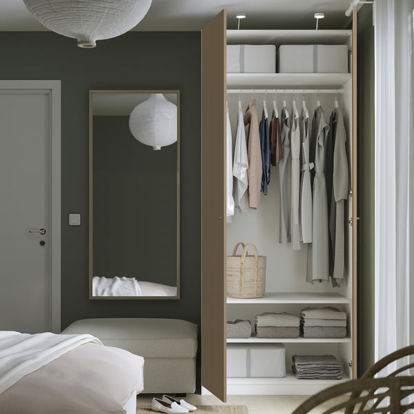 Bedroom closet open: mirror, clothes, shelves, baskets, dark green wall.