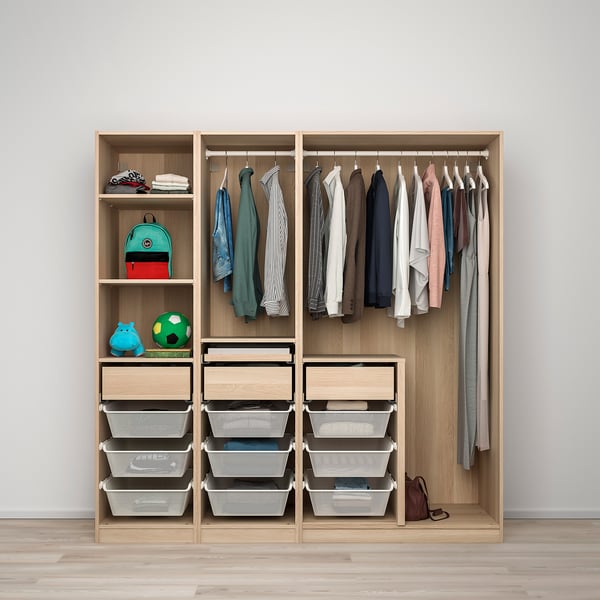A wooden kids wardrobe with shelves, drawers, and hanging space for clothes and toys.