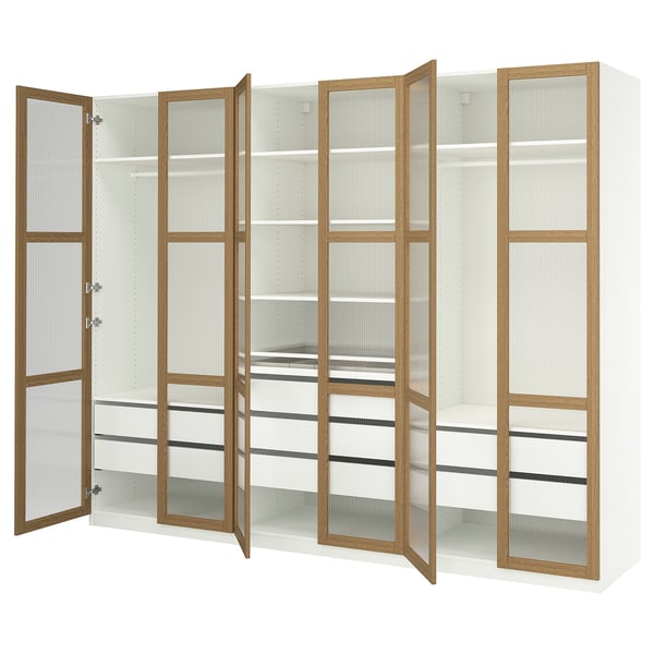 White ikea PAX wardrobe, featuring glass doors with wooden frames, open to reveal a spacious interior with multiple shelves and drawers.
