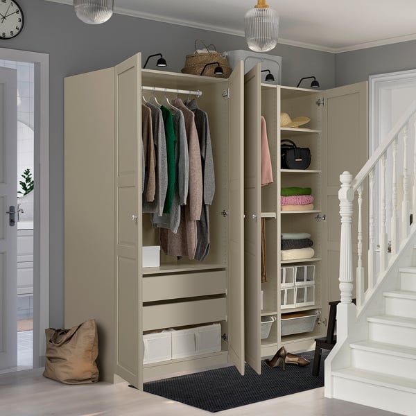 An open wardrobe unit displays clothes, accessories, and storage solutions in an organized entryway.