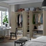 Modern bedroom with PAX wardrobes showing organized clothes storage.