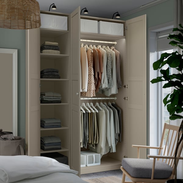 Modern bedroom with open wardrobe showing clothes storage, shelves, and adjustable lighting.