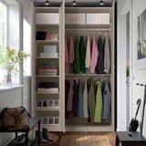 Organized closet with clothes, shelves, boxes, and hanging rail for efficient storage.