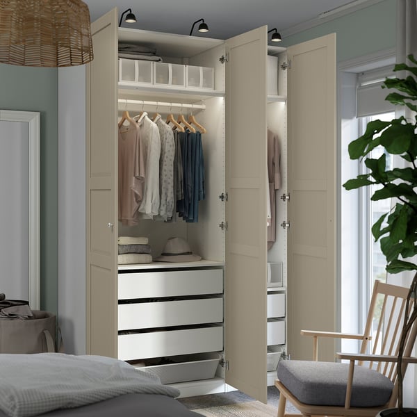 Modern bedroom wardrobe with hangers, drawers, and shelves. Clothes are neatly organized, and led lights illuminate the interior.