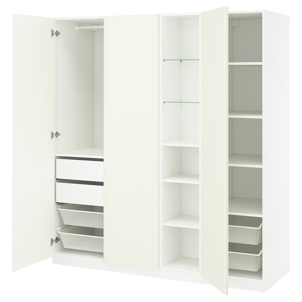 White PAX wardrobe, open showing shelves, drawers, baskets. Modern, minimalist design for organized storage.
