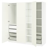 White PAX wardrobe, open showing shelves, drawers, baskets. Modern, minimalist design for organized storage.