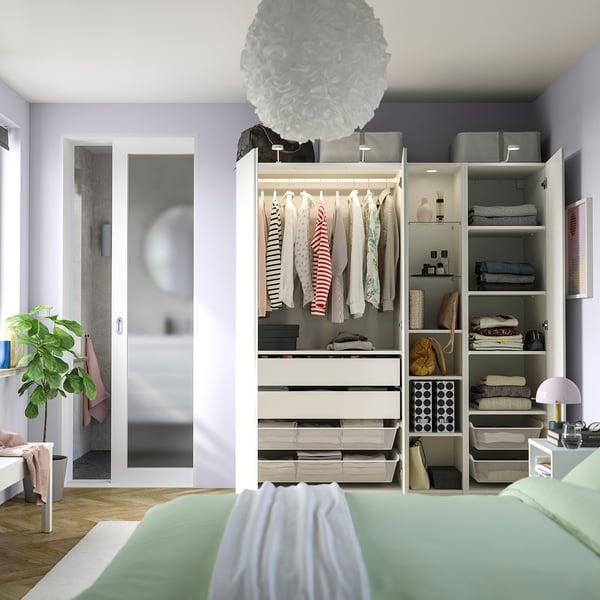 Modern wardrobe with hanging clothes, shelves, and drawers, featuring integrated lighting and a slow-closing door.