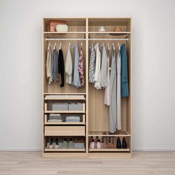 A modern wooden wardrobe with hanging clothes, folded items, and shoes. Includes drawers with glass fronts for easy access and organization.