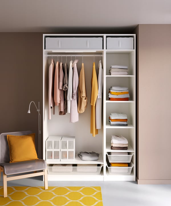 Organized closet with clothes, accessories, white-yellow accents, mesh baskets, steel railings, three shelves, one drawer.