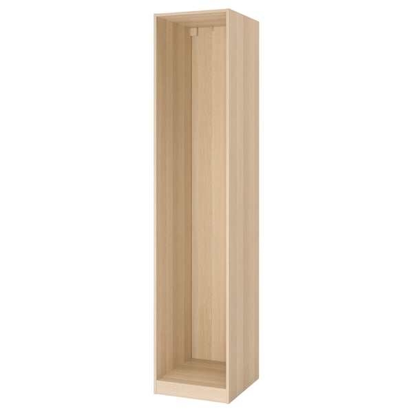 A light-colored wooden PAX wardrobe frame, standing upright and empty. Its rectangular with smooth edges and a simple, minimalist design.