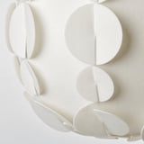 Modern pendant lamp with textured, semi-transparent shade resembling a sea urchin shell, emitting soft light.