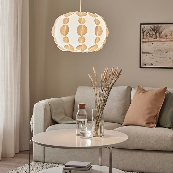 Modern living room with PEKTOLIT lamp above beige sofa and coffee table.