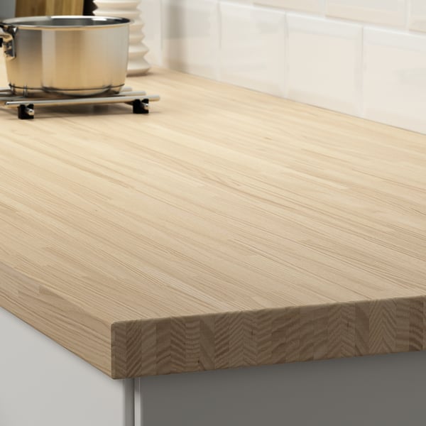 Wooden kitchen countertop with smooth surface and visible grain pattern.