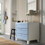 Modern gray blue PLATSA drawer set with lamp and mirror in clean, minimalist room.