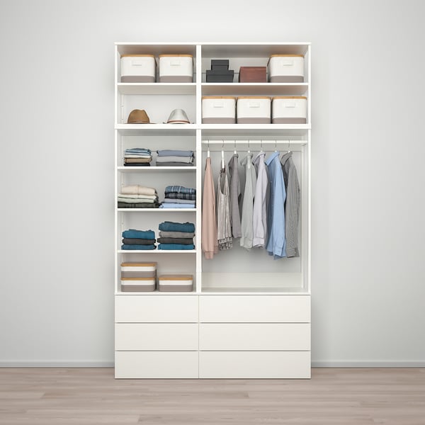 White wardrobe with shelves, drawers, and hanging space, showcasing organized clothing and accessories.