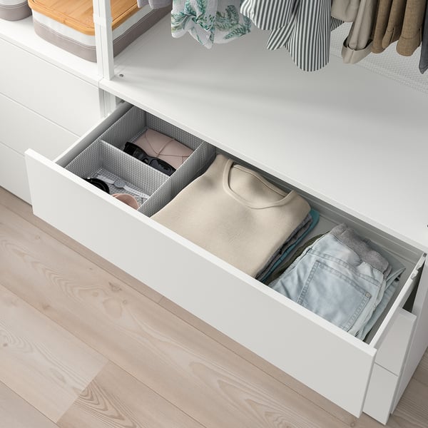 Open PLATSA drawer displaying folded clothes and accessories.