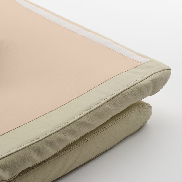 Close-up of soft, high-quality leather cushion, showcasing its stitching and texture.