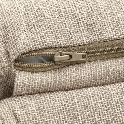 Close-up of a zip on a textured, beige fabric bag, highlighting quality craftsmanship.