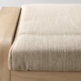Close-up of POÄNG footstool, showcasing its textured, woven fabric and sturdy, wooden frame, highlighting comfort and quality.