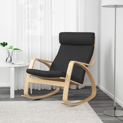 Modern rocker chair with dark gray cushion and light wood frame in living room.