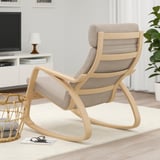 Modern rocking chair with cushions in cozy living room.