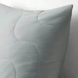 Light grey turquoise pillow with quilted wave pattern, soft texture, hidden zipper.