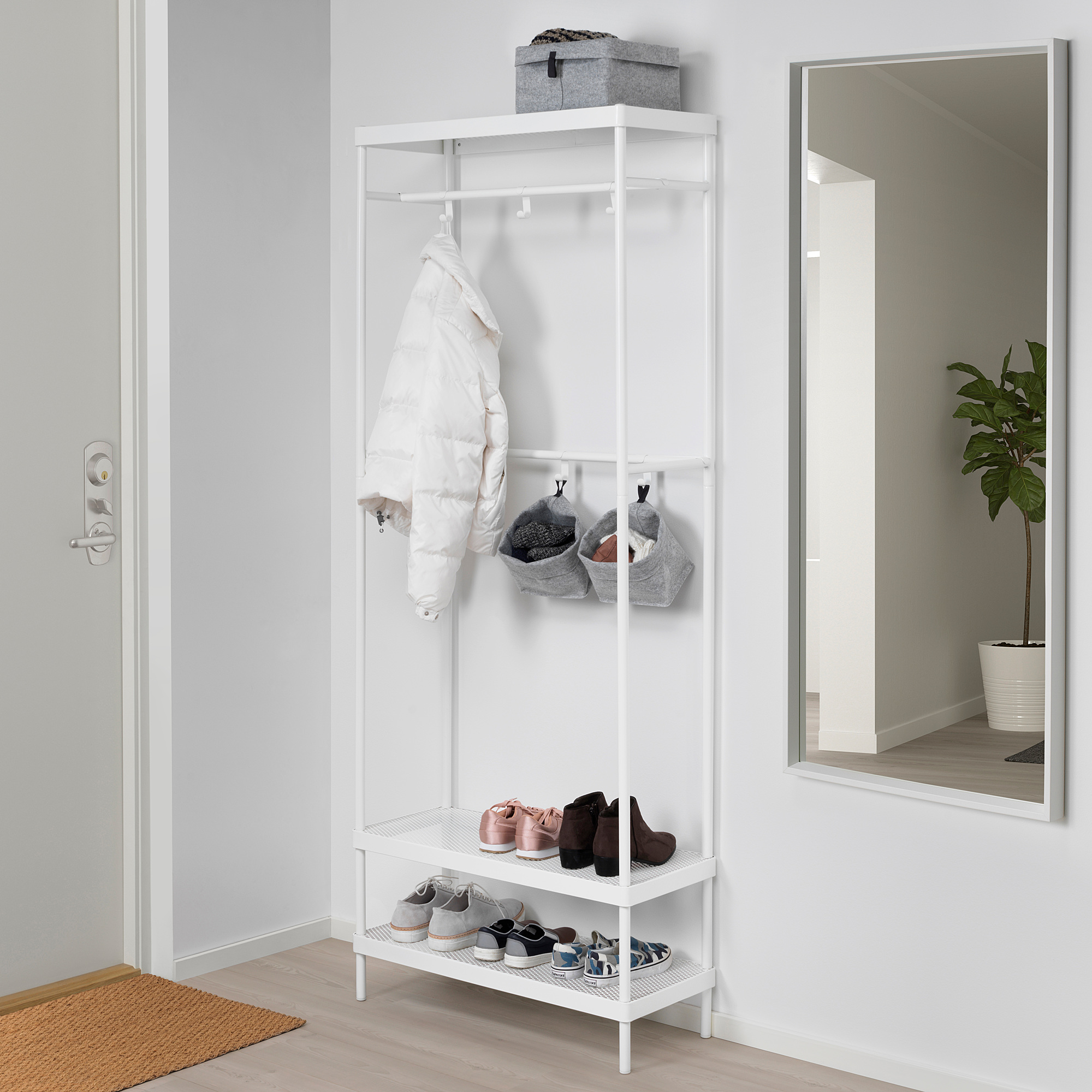 Tidy entryway with RAGGISAR white shoe rack, baskets, jacket, and mirror. Slim size.