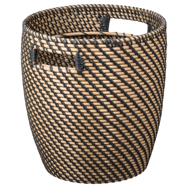 A RÅGKORN woven basket in black and natural tones with handles, made from polyethylene and polypropylene plastic.