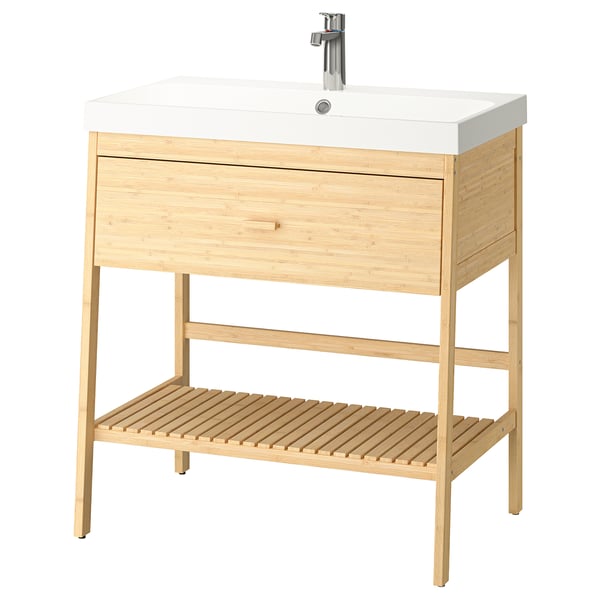 A light wooden bathroom vanity with a white sink and chrome faucet.