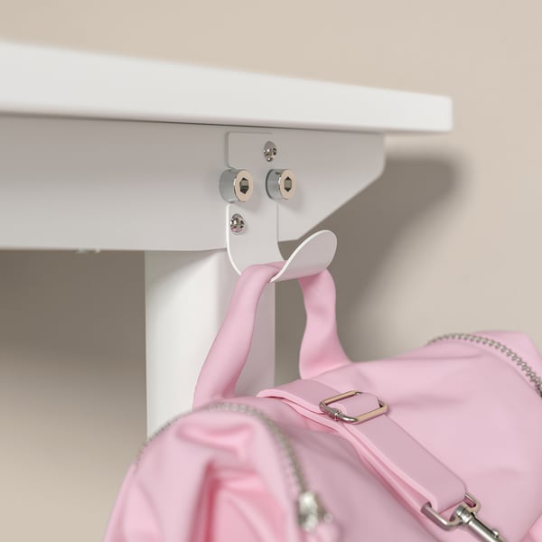 A white adjustable desk with pink backpack hooked on, featuring a handle for height adjustment.