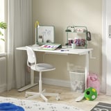 Childs white sit-stand desk with adjustable crank, gray cushioned chair, and organized accessories.