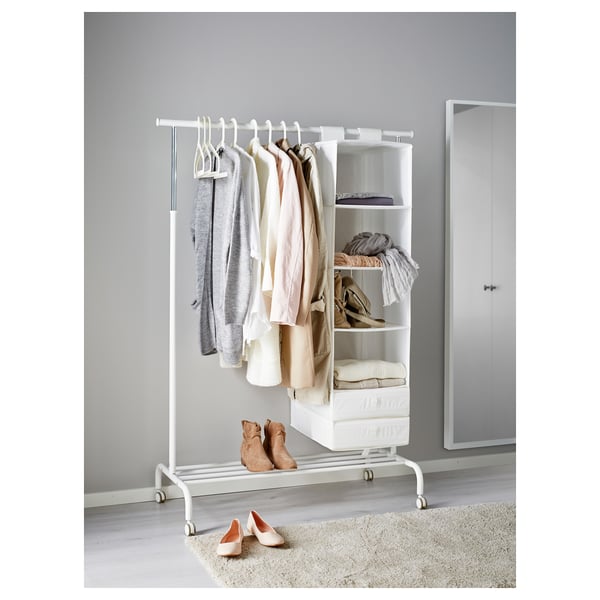 RIGGA clothes rack with adjustable shelves and hanging bar, holding various items.