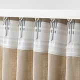 This image shows multiple curtain hooks with gathering tape, which allow for easy curtain hanging.