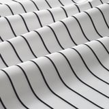 Close-up of RINNIG apron in black and white stripes, showcasing water-repellent texture and quality stitching.