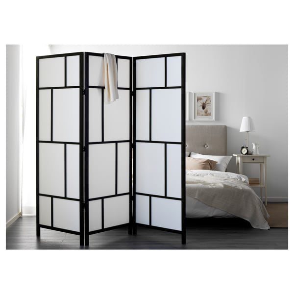 Black & white RISÖR grid divider by bed.