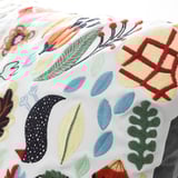 Embroidered cushion, vibrant colors & patterns. High-quality stitching, intricate leaf & floral designs.