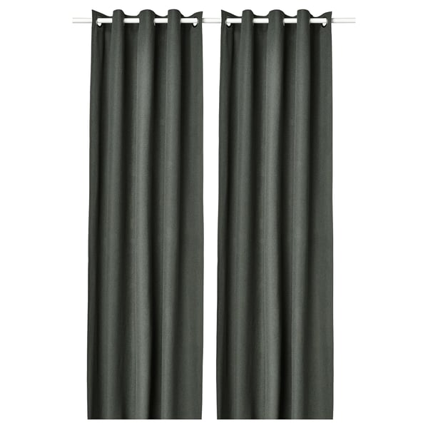 Two dark green, solid panel curtains hang side by side with eyelet headers.