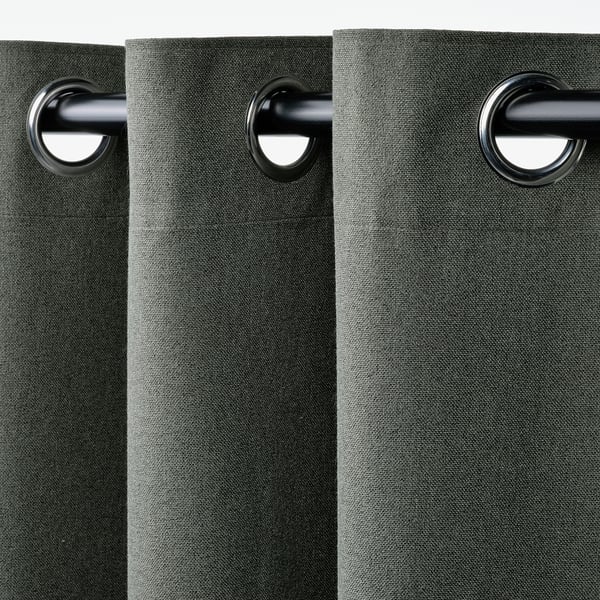 Dark green curtains with eyelets, blocking light, hanging smoothly, paired easily.