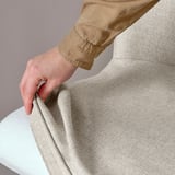 Hand grips ROSENTORP chairs soft, textured kilanda fabric, showing swivel function.